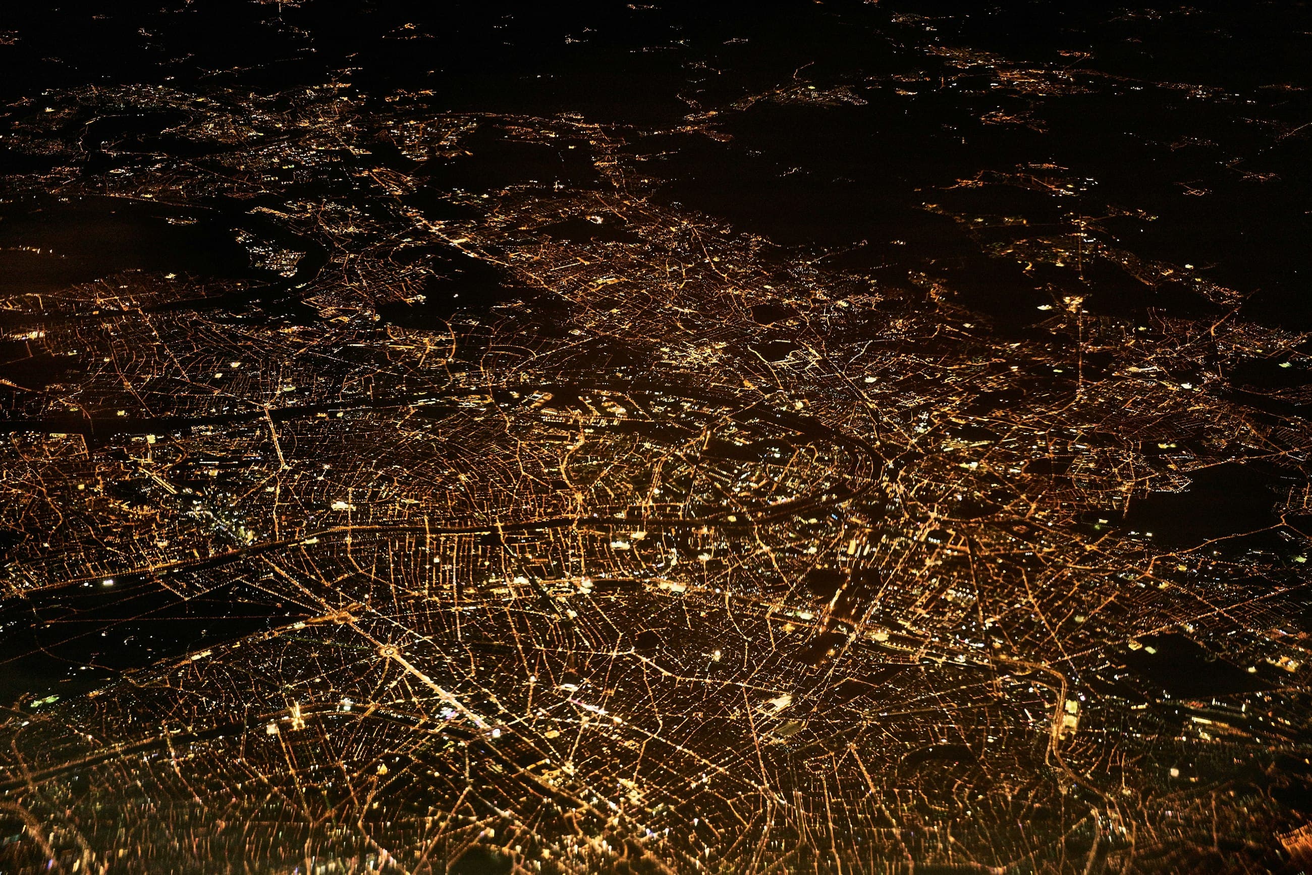 A city at night from the air, every street lit.